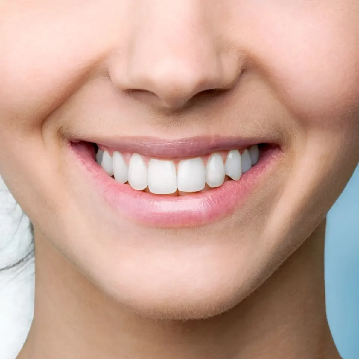 A woman with a bright smile showcasing her white teeth after undergoing teeth whitening treatment