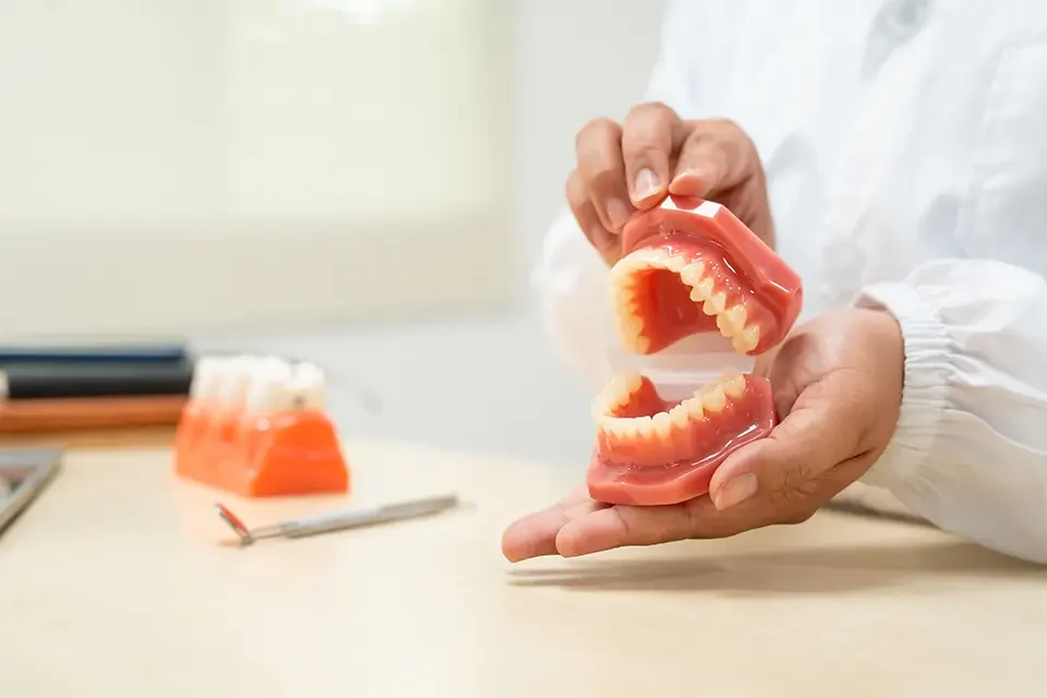 a-female-doctor-sits-at-a-table-in-a-hospital The Benefits of Snap-On Dentures