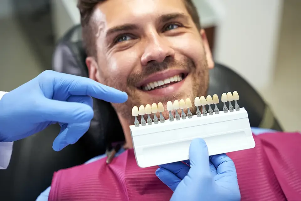 smiley-young-man-showing-teeth-to-his-dentist Why Patients Choose Composite Veneers