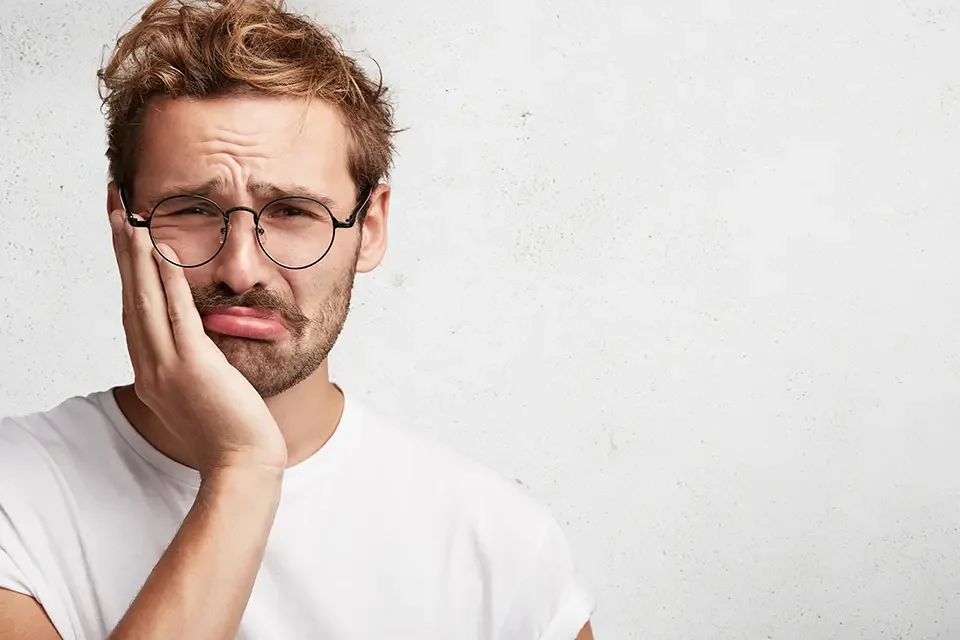 sorrowful man with toothache 10 Best Home Remedies for Toothache