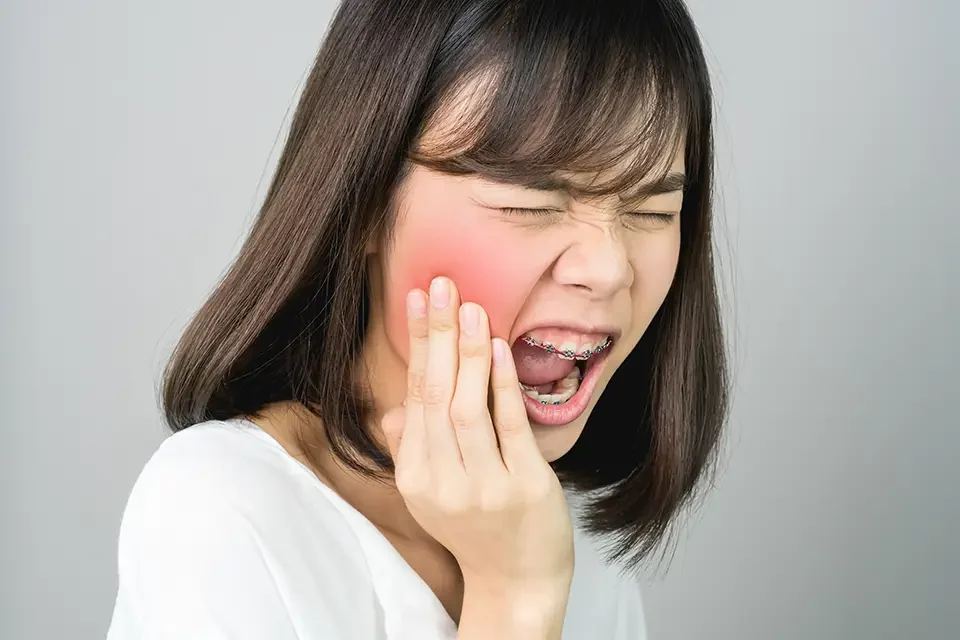 woman in tooth pain Understanding an Infected Wisdom Tooth