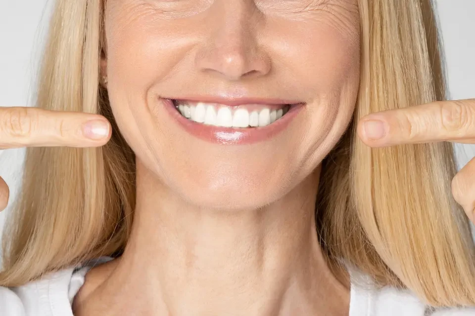 woman smiling close up Common Side Effects of Dental Implants