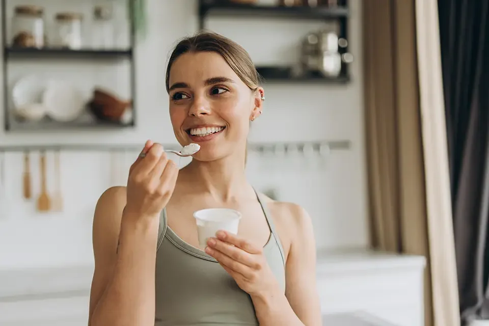 young woman eating Best Soft Foods to Eat After a Oral Surgery